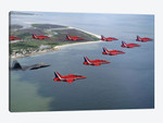 A F-22 Raptor Flies In Formation With The Royal Air Force Aerobatic Team, The Red Arrows