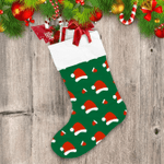 Santa Hat And Christmas Gloves On Green Background Christmas Stocking